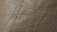 Luxury brown leather texture with decorative stitching pattern creating geometric diamond shapes for upholstery and interior design projects.