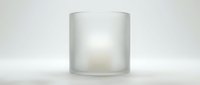Frosted glass candle holder with warm glowing light inside on white surface. Modern minimalist home decor accessory for ambient lighting and relaxation.