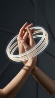 Female hands holding glowing neon light rings against dark background. Warm and cool tones create modern, artistic effect suitable for technology, innovation, and creative concepts.