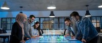 Diverse business team analyzing holographic building blueprint on futuristic digital table in modern office, collaborating on urban architecture project.