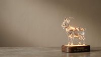 Crystal goat trophy figurine on wooden base with engraved nameplate, isolated against neutral background for award recognition and achievement celebration purposes.