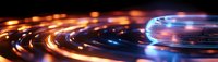 Futuristic light trails creating dynamic circular patterns with vibrant orange and blue glowing streaks against dark background.