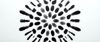 Overhead view of black footprints arranged in circular pattern on white background, representing diversity, community, and unity for design projects.