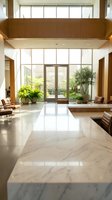 Modern luxury hotel lobby with marble floors, floor-to-ceiling windows, wooden accents and green plants creating elegant hospitality interior space.