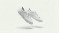 White leather sneakers floating on neutral background for fashion advertising and product photography campaigns.