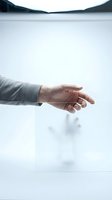 Business professional extending hand for handshake in modern office environment with mountain landscape view through window for corporate meetings.