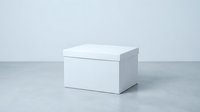 White cardboard box with lid on gray surface against light background for packaging mockup and product presentation needs.