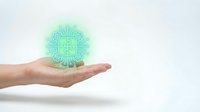 Hand holding glowing turquoise digital medical cross symbol with circuit pattern, representing healthcare technology, telemedicine, and digital medicine innovation.