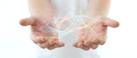 Female hands cupped together holding glowing network connections with light beams and digital links floating above palms on white background.