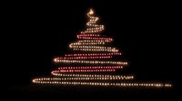 Glowing Christmas tree made of warm golden lights on black background for holiday decorations and festive seasonal designs.