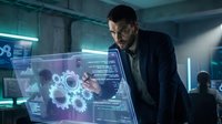 Businessman analyzing futuristic holographic data interface with digital charts and gears in modern tech office environment.