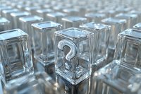 Transparent glass cubes with question mark symbol arranged in rows, creating modern minimalist composition with depth of field effect and reflective surfaces.