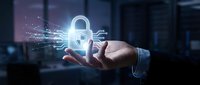 Businessman holding glowing digital padlock with shield icon, representing cybersecurity, data protection, and network safety in modern technology.