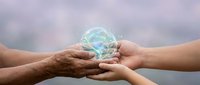 Hands of different generations holding glowing digital earth globe symbolizing environmental protection, sustainability and global unity concept.