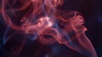 Abstract colorful smoke swirls in pink and blue hues creating elegant flowing patterns against dark background for creative design projects.