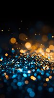 Magical blue and gold bokeh lights creating dreamy abstract background with glowing particles and blurred circles for festive or celebration designs.