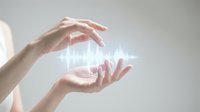 Protective hands surrounding glowing digital waveform representing data security, healthcare technology, sound waves, or energy protection in modern business environment.