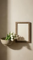 Minimalist home decor with white tulips in ceramic bowl and wooden picture frame on neutral beige wall with natural sunlight shadows creating warm atmosphere.