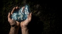 Human hands cupping glowing holographic figures representing human evolution from ape to modern man against dark textured background for science concepts.