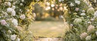 Romantic wedding ceremony arch decorated with white and pink flowers creating dreamy bokeh background for outdoor celebration and special events.