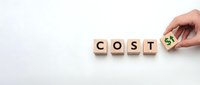 Hand placing wooden blocks spelling COST with dollar sign, business expense management and financial planning concept for budget analysis.