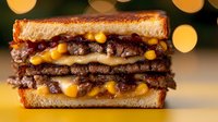 Juicy double beef patty sandwich with melted cheese and mustard sauce between toasted bread slices, close up view on blurred bokeh background.