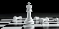 White king chess piece standing on chessboard with fallen pawns in background, dramatic lighting creates contrast and depth, symbolizing leadership and strategy.