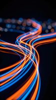 Glowing neon light trails in orange and blue intertwine against dark background with bokeh effects, representing data flow, connectivity, energy, and modern technology concepts.
