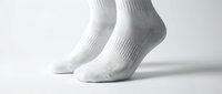 White ankle socks on feet against a light background, showcasing clean cotton sportswear for athletic and everyday casual wear.
