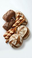 Assorted artisan breads including crusty sourdough loaves, twisted pretzel, and scored rye rolls arranged on white background. Bakery products for food photography, culinary design, restaurant menus, and bakery marketing materials.