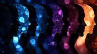 Silhouettes of faces in profile filled with cosmic space and glowing particles transition from blue through purple to orange creating dreamy atmospheric effect.