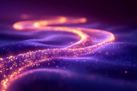 Glowing curved light trail with sparkling particles against purple background creates magical atmosphere for festive designs and holiday projects.