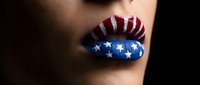 Woman with patriotic flag makeup on lips featuring red white blue stars and stripes design for Independence Day celebration and national pride themes.