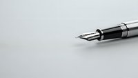 Elegant fountain pen with silver and black design on clean white background for professional writing and business correspondence.
