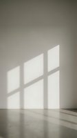 Minimalist interior corner with natural window light casting geometric shadows on white wall and polished concrete floor for modern architecture design.