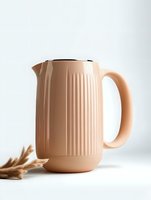 Modern peach-colored electric kettle with vertical ribbed texture on white background, styled with dried wheat stalks for minimalist kitchen decor photography.