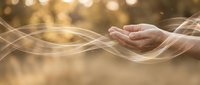 Open hands with flowing energy waves and golden bokeh lights creating spiritual healing atmosphere for wellness meditation concepts.