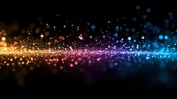 Magical glowing particles flowing in rainbow colors from gold to pink and blue on black background, creating dreamy bokeh effect for festive designs.