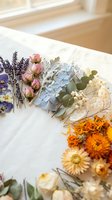 Dried flower arrangement with lavender, roses, hydrangea and marigolds on white paper for crafting, scrapbooking and botanical art projects.