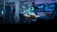 Business professional analyzing holographic financial data and charts in modern office environment for investment strategy and market research.