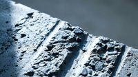 Close-up of wet car tire tread with water droplets showing detailed rubber pattern and grip texture for automotive safety and performance concepts.