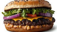 Gourmet burger with sesame seed bun, beef patties, melted cheese, crispy onions, fresh lettuce, tomato and red onion slices on white background for food photography and menu design.
