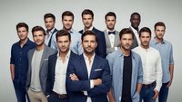 Group of diverse professional men in business casual attire standing together in studio portrait on neutral background for corporate team concept.