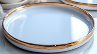 Elegant white ceramic plate with luxurious rose gold rim on reflective surface. Modern tableware design combines minimalist style with metallic accent for upscale dining.