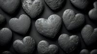 Stone hearts arranged in dark moody composition with dramatic lighting and textured surface creating romantic yet mysterious atmosphere for valentines designs.