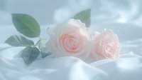 Delicate pink roses with soft green leaves lying on white silk fabric in dreamy ethereal lighting, creating romantic and serene atmosphere for wedding or anniversary designs.