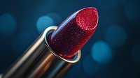 Sparkling dark red lipstick with glitter texture against blurred blue bokeh background, macro cosmetic photography highlighting luxury makeup product detail.