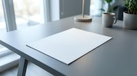 Clean minimalist workspace with blank white paper on modern desk near window with coffee cup and plant for business planning and creative projects.