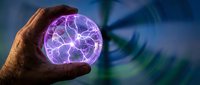 Hand holding glowing purple plasma ball with electric energy crackling inside, isolated on blurred tech background for science, technology, and innovation concepts.