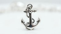 Vintage silver anchor with rope detail on white background, suitable for nautical, maritime, and decorative design projects.